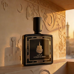 Al Hajar Al Aswad perfume bottle 80ml from taif al emarat perfumes resting on a marble with Islamic portraits - fine oud fragrance