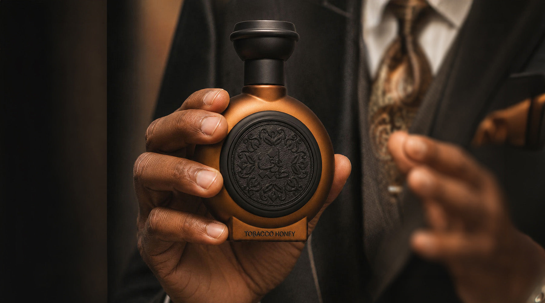 Man In A Suit Holding Taif Al Emarat Perfume Bottle - Luxury Perfume Brands, Dubai UAE