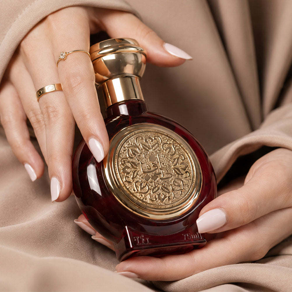 Hands with rings carrying TAIF 11 women's perfume bottle 75ml gently, best ladies perfume in uae