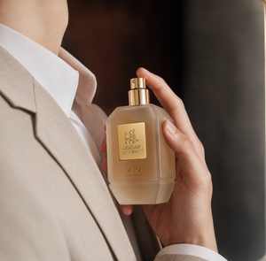Man in a suit holding V10 unisex perfume bottle 75ml - best arabian oud fragrance in dubai