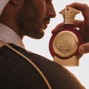 Man smelling Qatar unisex perfume bottle 75ml from taif al emarat perfumes - top unisex perfume