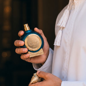 a man in traditional arabian dress holding Oman unisex perfume bottle 75ml in traditional attire - premium Smoked Oud perfume