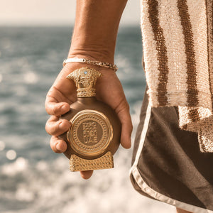 Hand holding Expo 2020 unisex perfume bottle 75ml from taif al emarat perfumes by the sea - best perfume