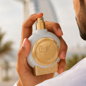 Hand holding EMIRATES LAND men's perfume bottle 75ml from taif al emarat perfumes - greatest men's fragrances of all time