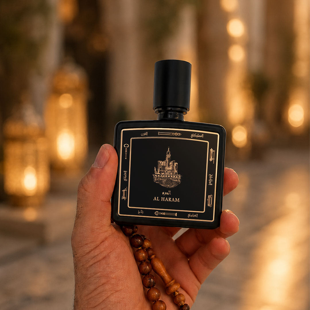 Hand holding Al Haram perfume bottle 80ml from taif al emarat perfumes with wooden beads - fragrant leather oud perfume