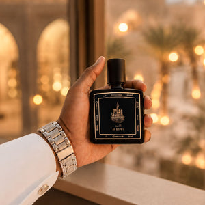 Hand holding Al Keswa perfume bottle 80ml from taif al emarat perfume, image showing luxury lifestyle - best arabian oud perfume