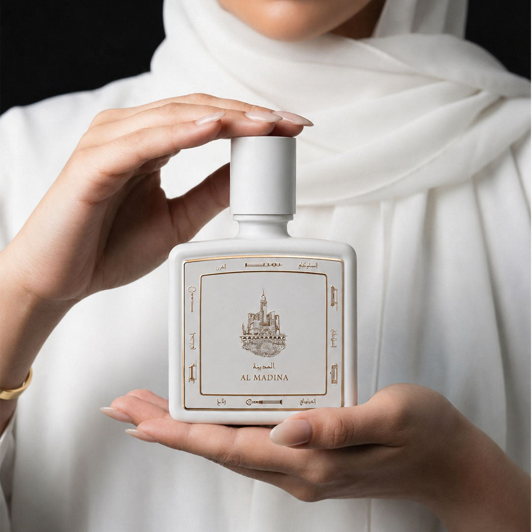 Hands holding Al Madina perfume bottle 80ml from taif al emarat perfumes - luxurious madina fragrance