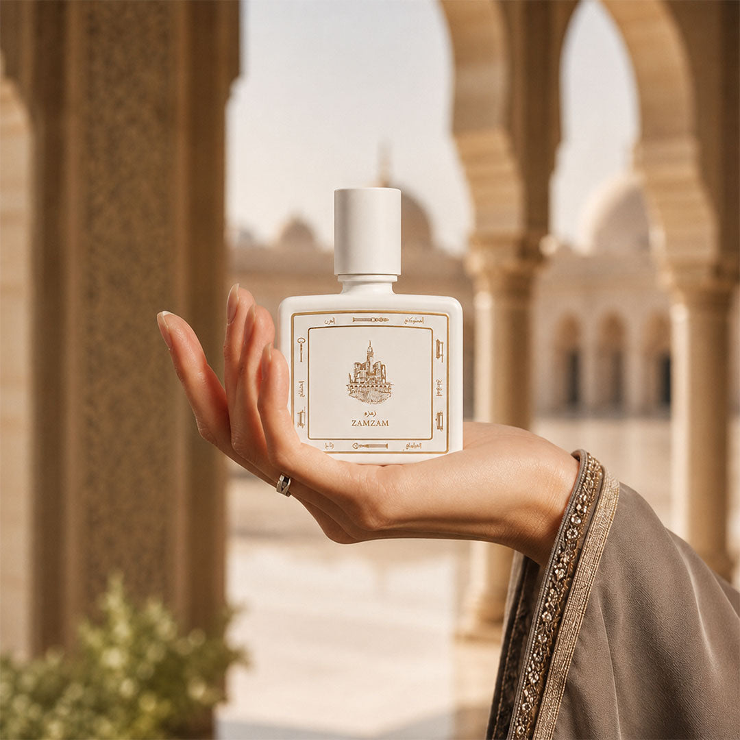 Hand holding Zamzam perfume bottle 80ml - white luxury perfume bottle embossed with golden portrait of mecca ciry - elegant cambodian oud perfume
