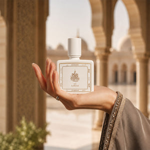 Hand holding Zamzam perfume bottle 80ml - white luxury perfume bottle embossed with golden portrait of mecca ciry - elegant cambodian oud perfume