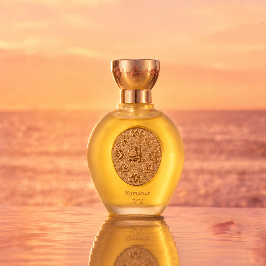 ROMANCE N°1 women's perfume bottle 75ml from taif al emarat perfumes glowing above sunset ocean waters - long lasting amber perfume